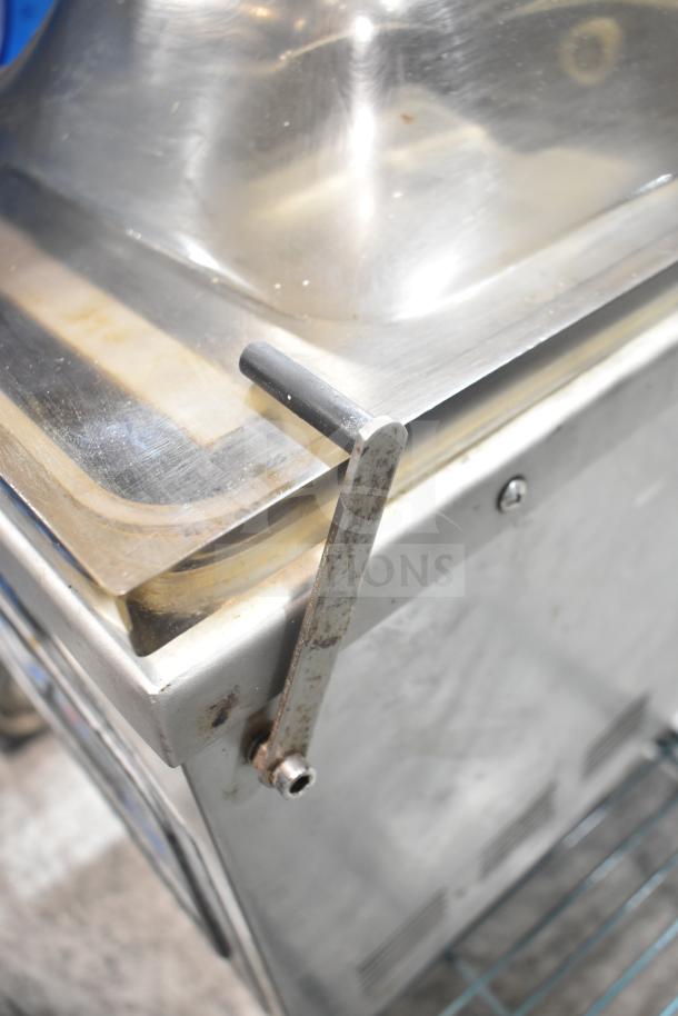VacMaster VP210 Commercial Vacuum Sealer with stainless steel body, lever, and transparent lid, showing wear.