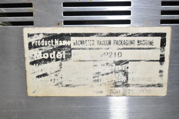 VacMaster VP210 vacuum sealer label showing model details, slightly worn condition, on stainless steel surface.