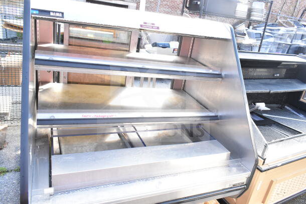 Custom Deli's DILW4SS commercial display case, stainless steel, floor style, 120/208V, 1 phase; "Caution Hot" label visible.