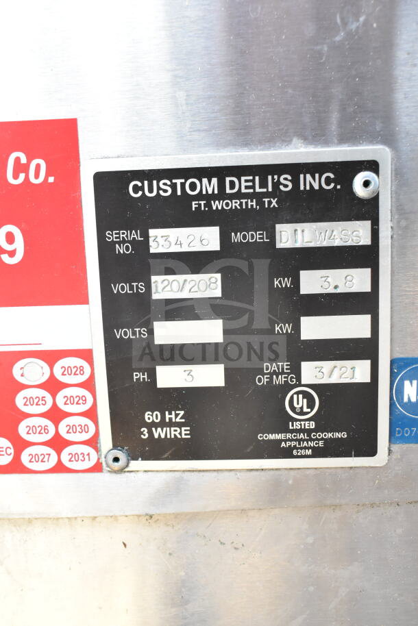 Custom Deli's DILW4SS display case label showing serial number 33426, 120/208 volts, 3.8 KW, manufactured 3/21.