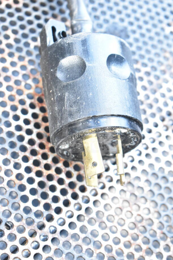 Black power plug for Commercial Floor Style Open Grab N Go Merchandiser, 120/208-240 volts, on perforated surface.