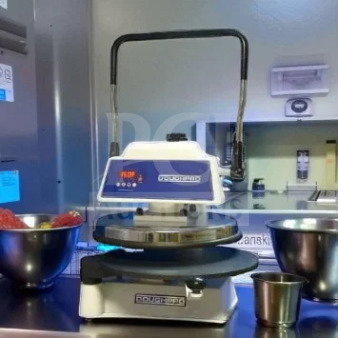 DoughPro DP1100 manual pizza dough press, well-maintained, AS-IS condition, steel handle, digital display, countertop model.