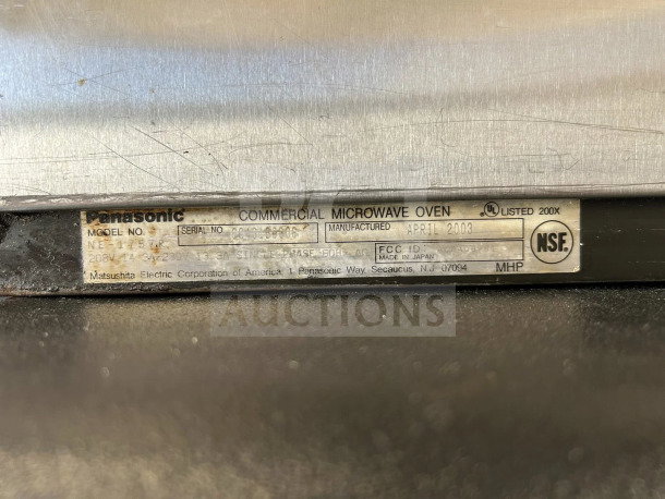 Close-up of Panasonic NE-17723 microwave oven label showing model, serial number, and April 2003 manufacturing date.