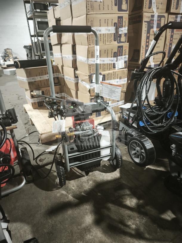 Husqvarna PW2300 electric pressure washer, tested and working, sturdy frame, two wheels, visible pump, handle, and detergent tank.