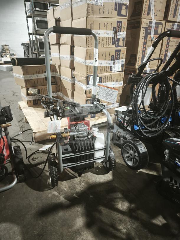 Husqvarna PW2300 electric pressure washer in tested, working condition; features sturdy wheels and ergonomic handle.