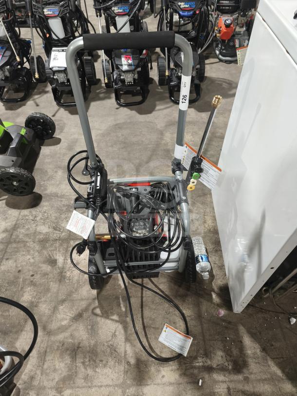 Husqvarna PW2300 Electric Pressure Washer, tested and working, featuring sturdy frame, hose, and nozzle attachments.
