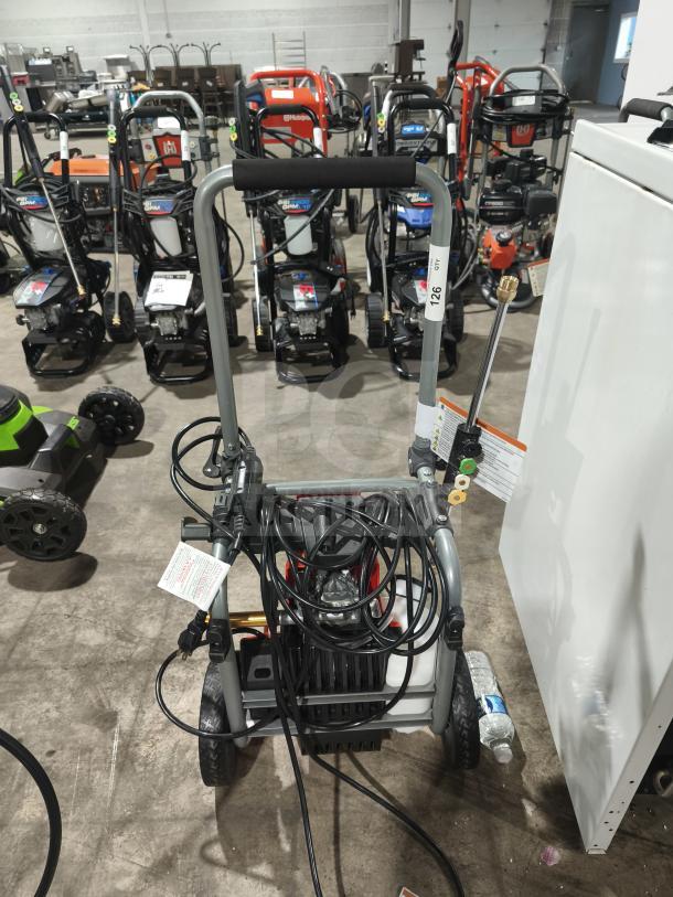 Husqvarna PW2300 Electric Pressure Washer, tested working, features hose and nozzle attachments, used condition.