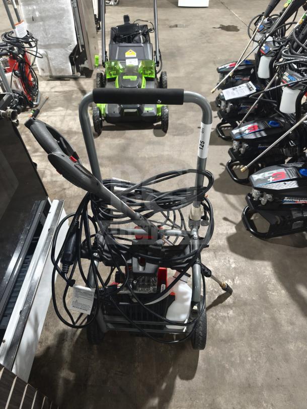 Husqvarna PW2300 electric pressure washer, tested and working, shown with hose and handle.
