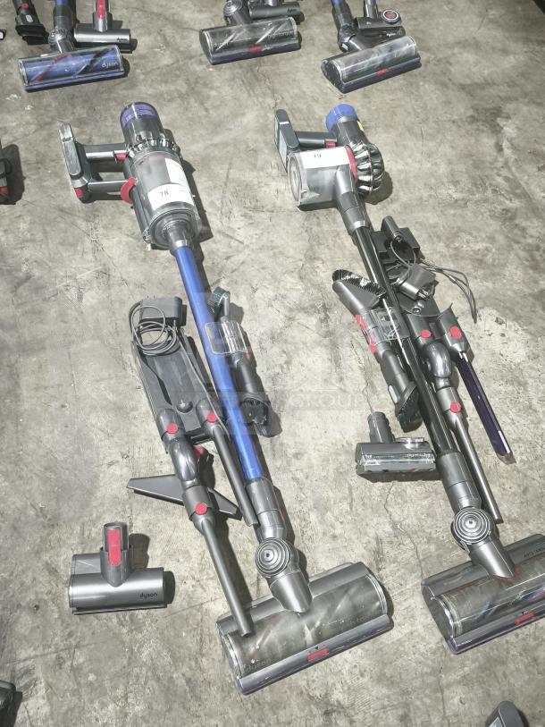 Dyson V11 Torque Drive PLUS cordless stick vacuum, tested and working, shown with attachments on concrete floor.