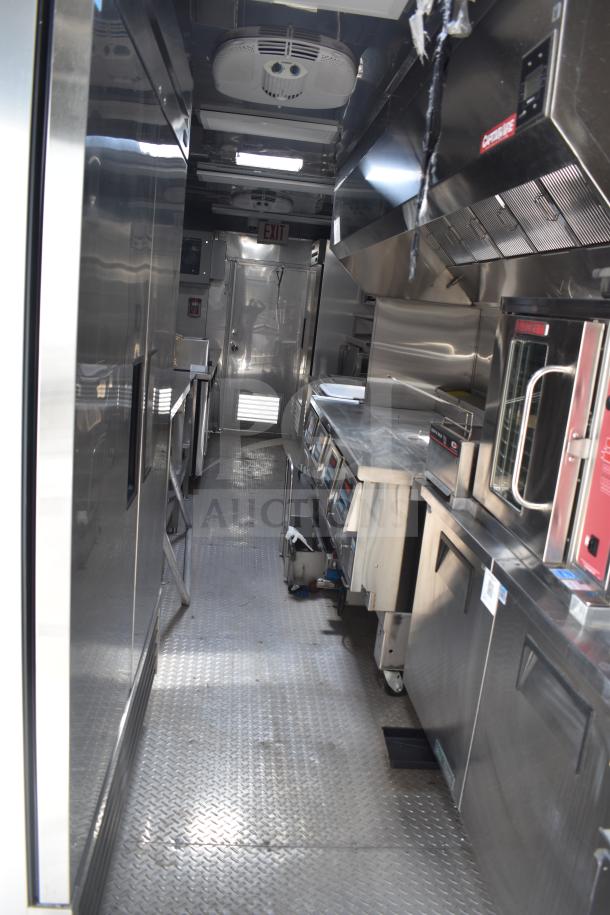 2021 Texino 28ft food trailer interior, featuring CaptiveAire hood, Ultrafryer 4-bay fryer, and full True refrigeration.