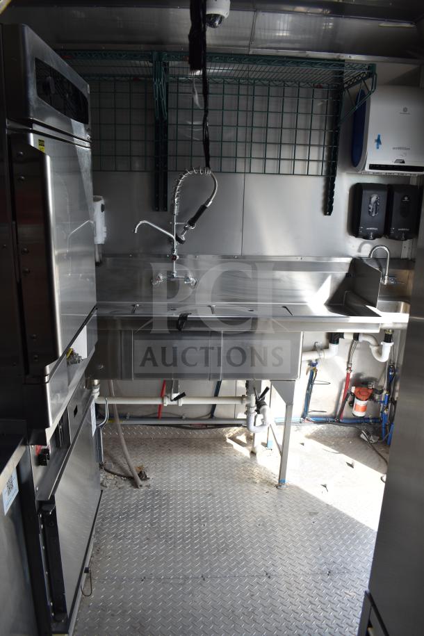 2021 Texino 28ft food trailer interior, featuring CaptiveAire hood, Ultrafryer 4-bay fryer, and full True refrigeration suite.