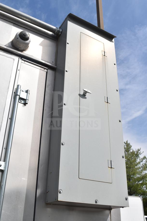 Exterior view of a 2021 Texino 28ft food trailer with a metal panel enclosure. The surface is clean and well-maintained.