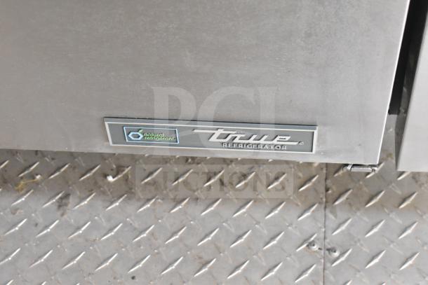True Refrigerator label on Texino food trailer, featuring natural refrigerant and stainless steel finish.