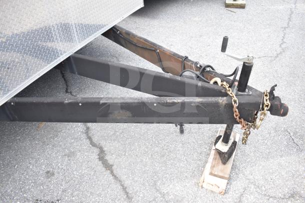 2021 Rock Solid Cargo 28ft food trailer hitch and chain detail. Well-maintained, sturdy triple-axle design.