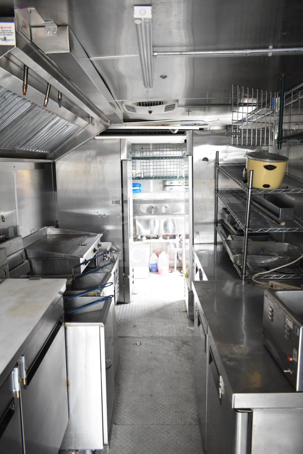 NBRHD Kitchens food trailer with dual Pitco gas fryers, CaptiveAire hood, Arctic Air refrigeration, and Daikin mini-split.
