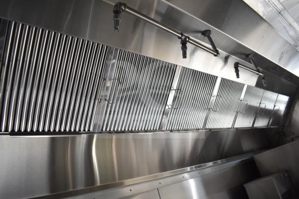 "Stainless steel CaptiveAire hood system in new 2021 Texino 28ft food trailer, featuring fire suppression nozzles and sleek design."