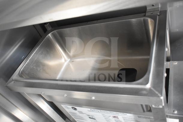 Stainless steel compartment in the 2021 Texino 28ft food trailer, featuring a triple-axle design and CaptiveAire hood.