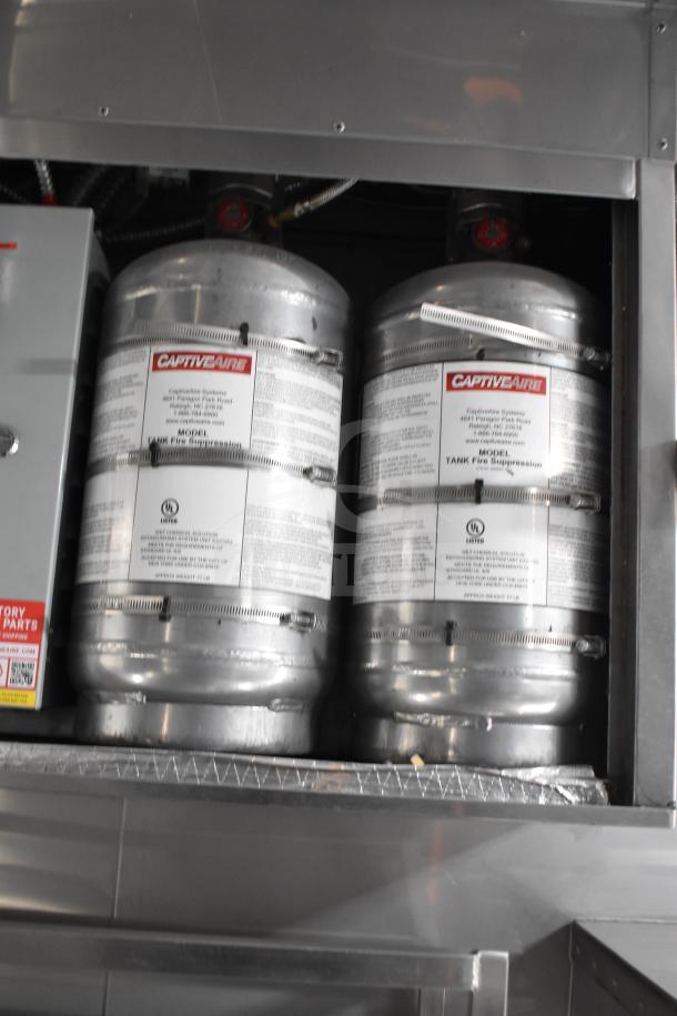 Texino 2021 food trailer's CaptiveAire fire suppression tanks in silver. Key safety feature. New condition.