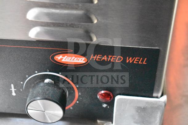 Close-up of Hatco Heated Well control knob, showing temperature settings and red indicator light on a commercial food trailer.