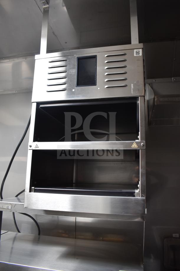 Stainless steel cooking unit inside 2021 Texino 28ft food trailer, featuring commercial-grade equipment, appears in new condition.