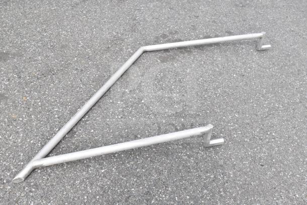 Metal trailer frame part on concrete surface. Appears to be a component of a larger structure like a food trailer.