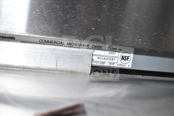 Label on a commercial microwave oven, shows "Panasonic." Marked "Manufactured 2021," UL listed, and NSF certified.