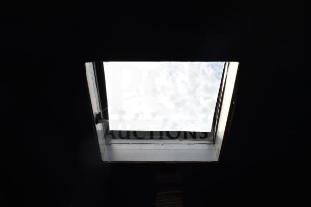Open skylight inside a 2021 Texino 28ft Triple-Axle Commercial Food Trailer, showing a view of the cloudy sky.