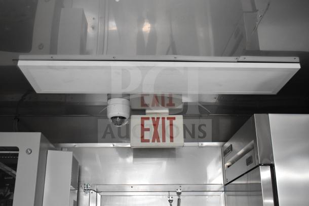 Interior of 2021 Texino 28ft food trailer showing EXIT sign, security camera, and stainless equipment.
