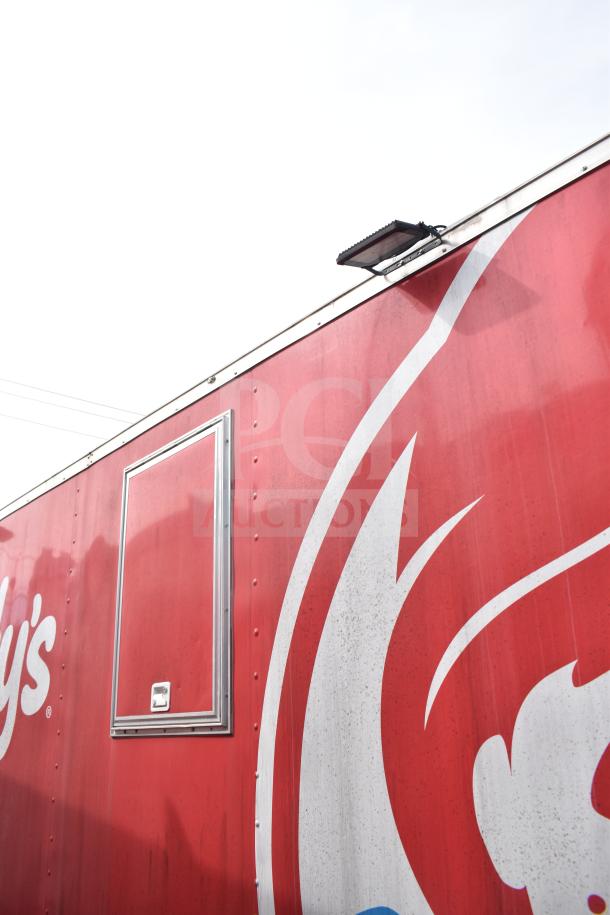 2021 Rock Solid Cargo 28ft food trailer, red exterior with logo, side hatch, well-maintained condition.