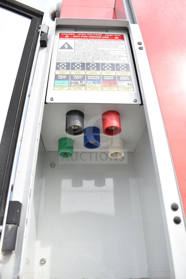 High-voltage electrical panel inside a 2021 Rock Solid Cargo 28ft food trailer, showing labeled connectors and safety warnings.