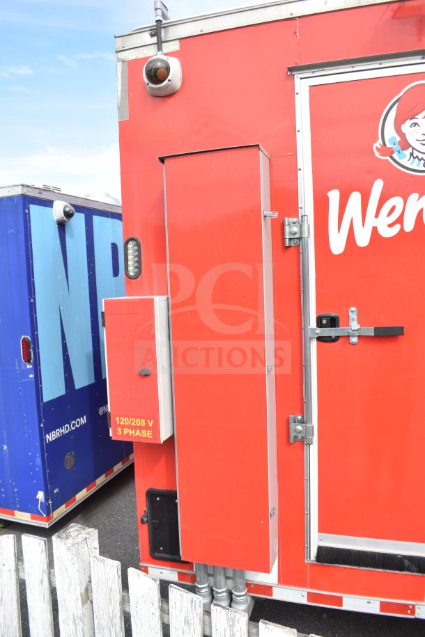 2021 Rock Solid Cargo 28ft food trailer with visible red exterior, industrial power access, and branded signage.