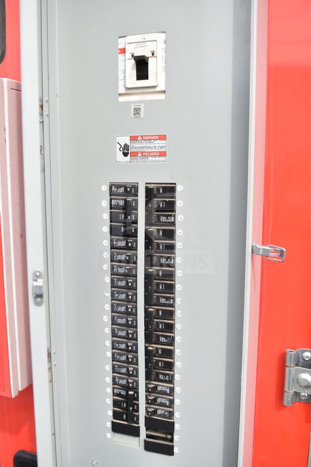 Electrical panel of the 2021 Rock Solid Cargo 28ft food trailer, featuring circuit breakers and safety warnings.