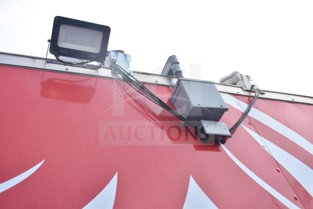 Exterior of a 2021 Rock Solid Cargo 28ft food trailer showing mounted lights and electrical equipment.