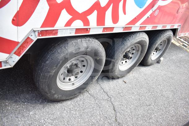 2021 Rock Solid Cargo 28ft triple-axle food trailer with visible tires. Features Henny Penny fryer, Taylor griddle, CaptiveAire hood.
