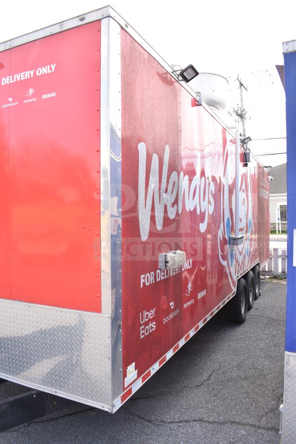 2021 Rock Solid Cargo 28ft food trailer, red exterior, triple-axle. Features logos for Uber Eats, DoorDash, Grubhub.