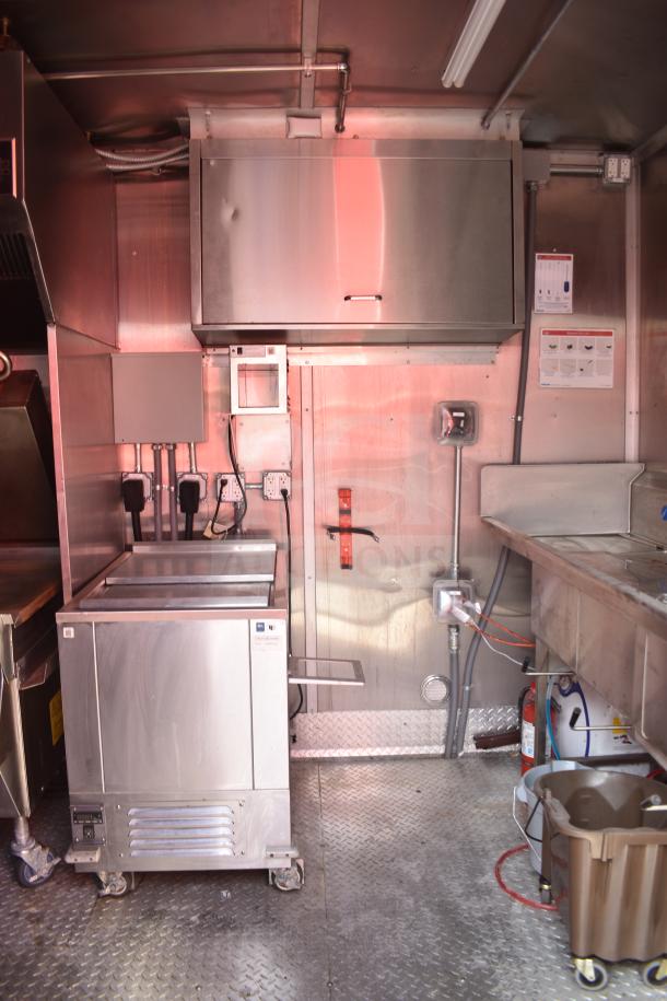 2021 Rock Solid Cargo 28ft food trailer interior with Henny Penny electric fryer, Taylor clamshell griddle, CaptiveAire hood.