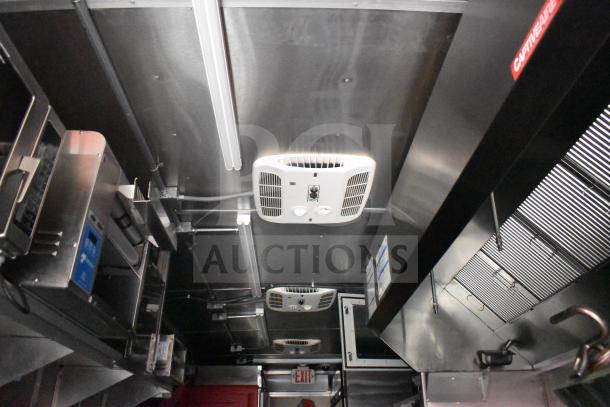 2021 Rock Solid Cargo 28ft food trailer interior with commercial kitchen setup, CaptiveAire hood, stainless steel surfaces.