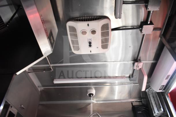 Interior view of 2021 Rock Solid Cargo 28ft food trailer showing HVAC unit and lighting fixtures on ceiling.
