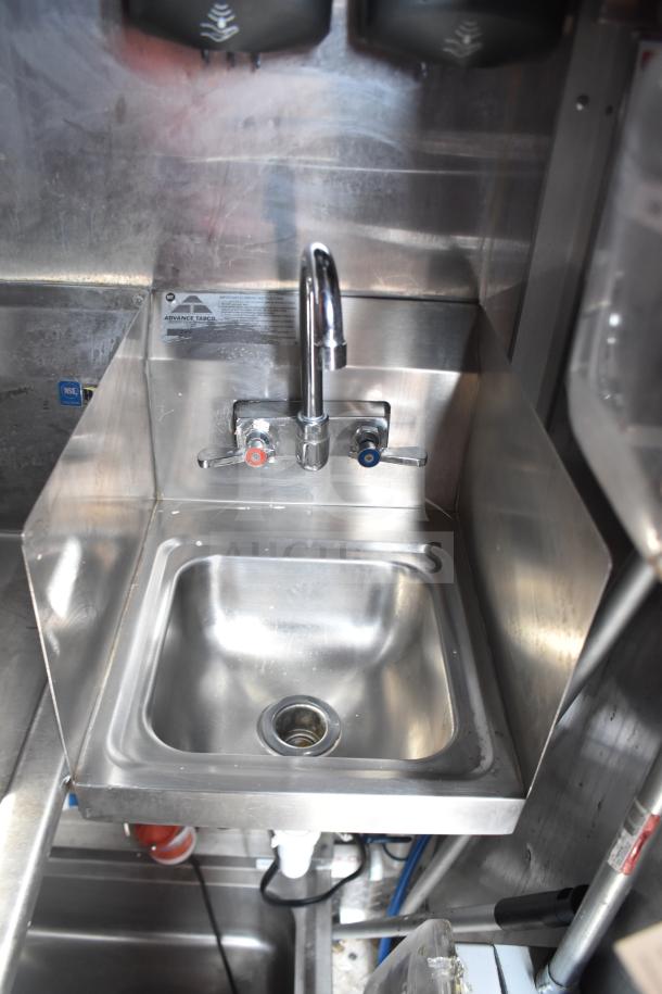 Stainless steel sink with faucet in a 2021 Rock Solid Cargo food trailer. Features visible label: "Advance Tabco."