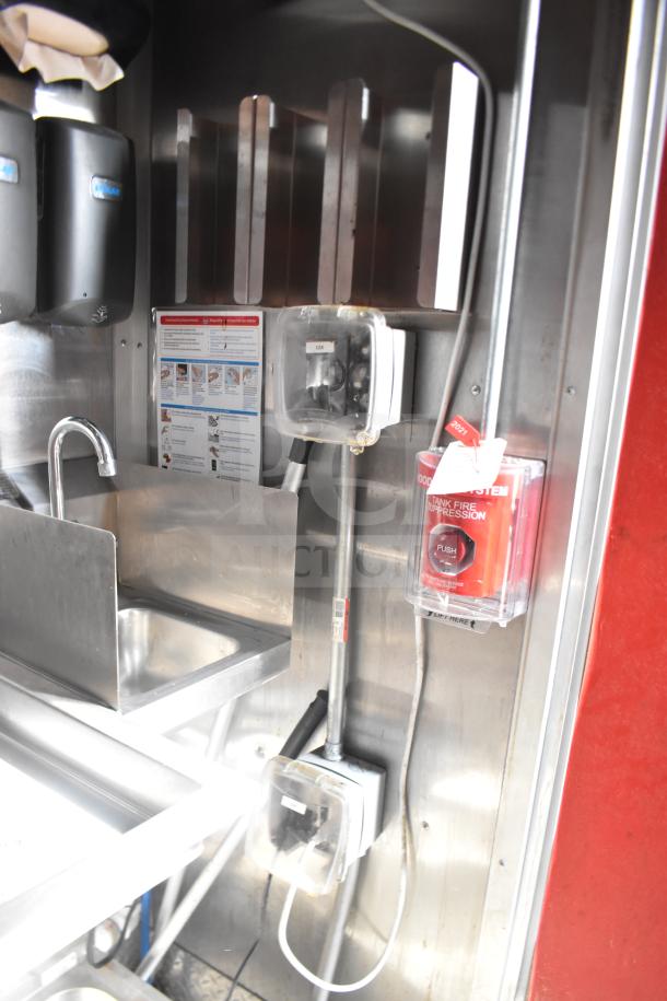 2021 Rock Solid Cargo 28ft food trailer interior showing a sink, fire suppression system, and control panels.