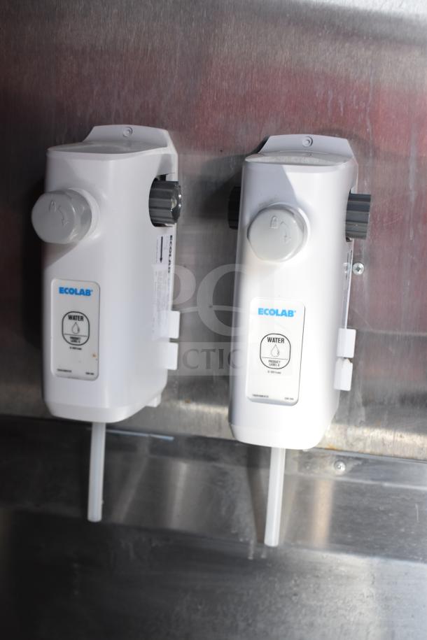 Ecolab water dispensers mounted on a wall inside a 2021 Rock Solid Cargo 28ft food trailer.