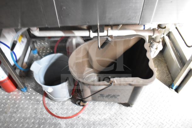 Interior view of a 2021 Rock Solid Cargo food trailer showing a mop bucket on metal flooring.
