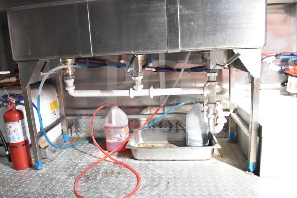 2021 Rock Solid Cargo 28ft food trailer sink area with plumbing and cleaning supplies, featuring fire extinguisher.