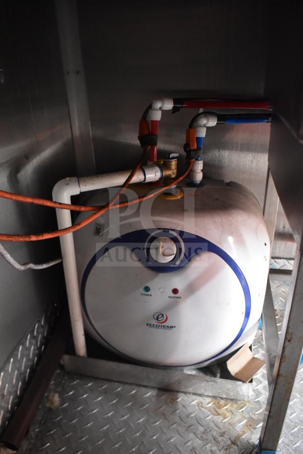 2021 Rock Solid Cargo food trailer interior showing an Eccotemp water heater, installed with piping and electrical connections.
