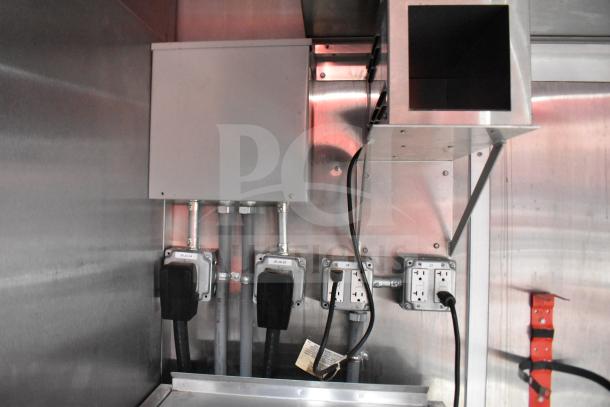 Interior view of a 2021 Rock Solid Cargo 28ft food trailer showing electrical outlets and wiring setup.