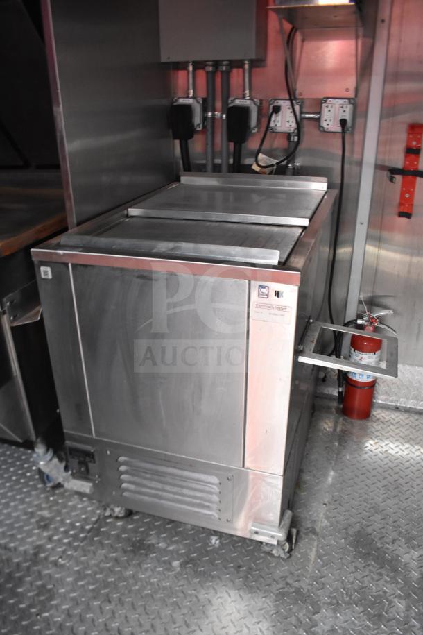 2021 Rock Solid Cargo 28ft food trailer interior; features electric fryer, griddle, commercial hood, refrigerator. VIN visible.