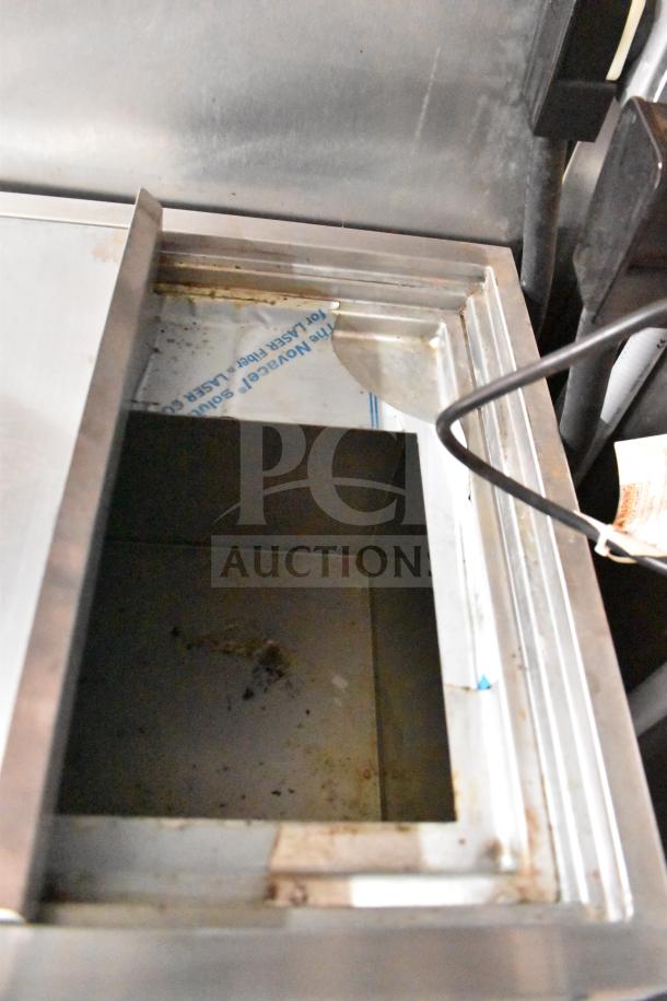 Interior view of stainless steel component in 2021 Rock Solid Cargo 28ft food trailer, showing wear and usage marks.