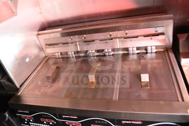 Henny Penny electric fryer in a 2021 Rock Solid Cargo food trailer, featuring a stainless steel lid and controls.