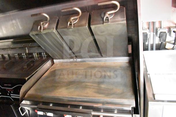 2021 Rock Solid Cargo 28ft food trailer featuring Taylor Clamshell Griddle, shown partially. Commercial-grade equipment.
