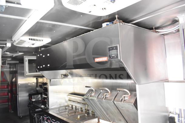 2021 Rock Solid Cargo 28ft food trailer interior with CaptiveAire hood, Henny Penny fryer, and Taylor clamshell griddle.